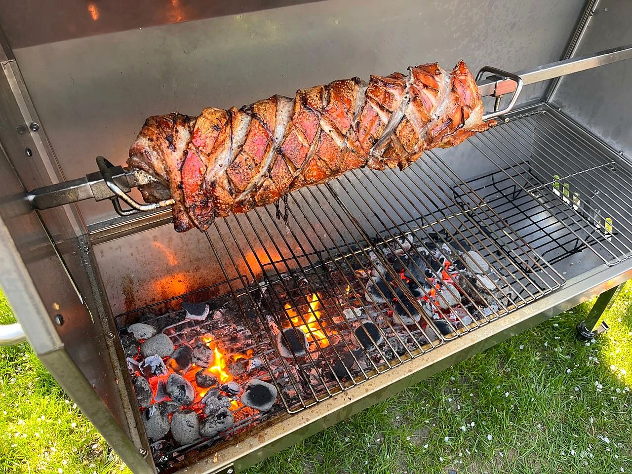 Rollbraten am Spieß über glühender Holzkohle